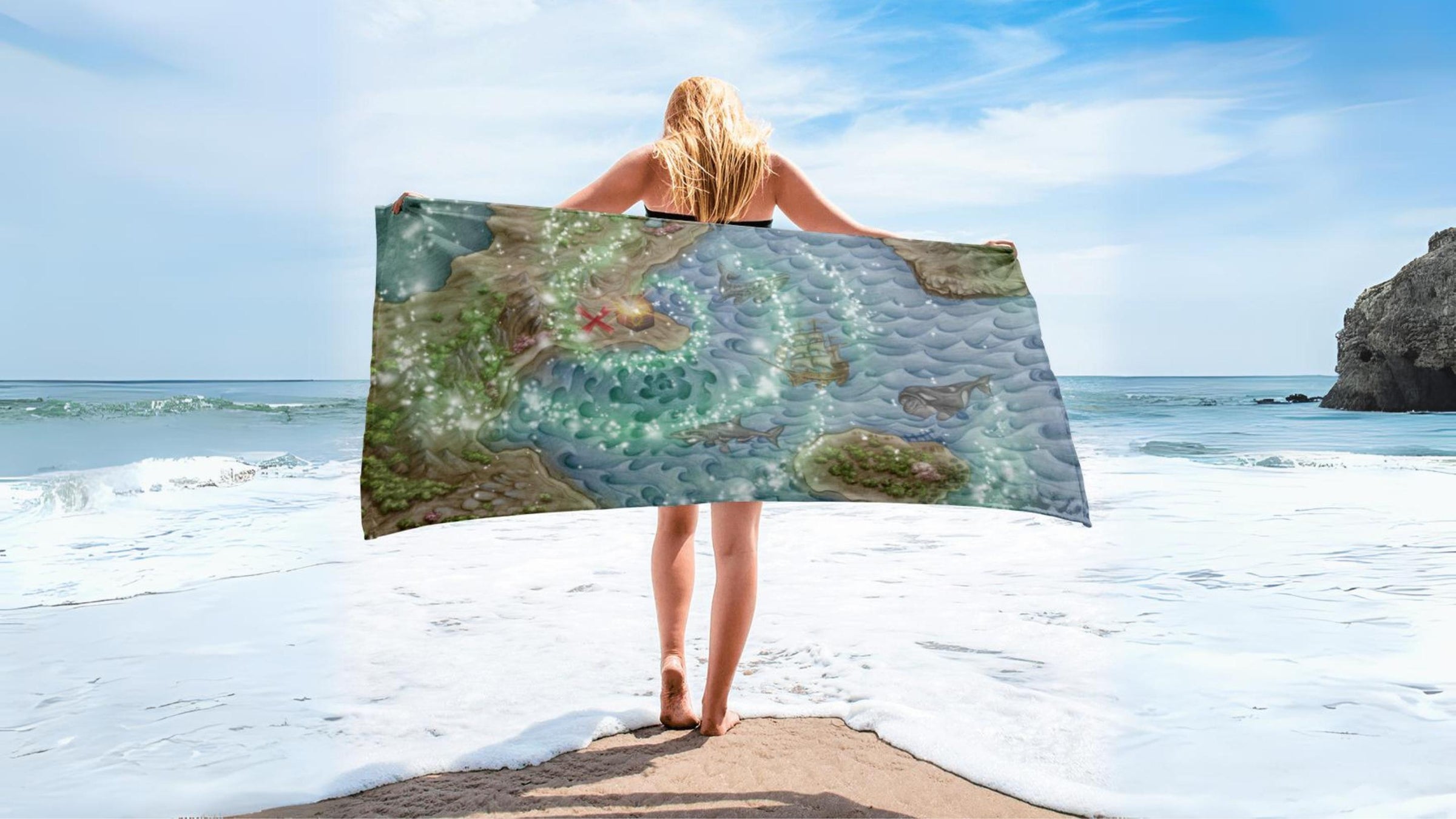 Beach towel with magical treasure map and a woman on a beach with ocean